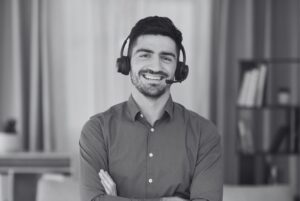 Man wearing headphones that work remotely in home office