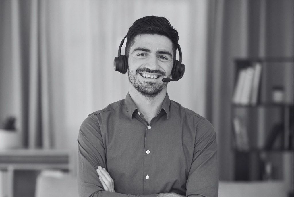 Man wearing headphones that work remotely in home office
