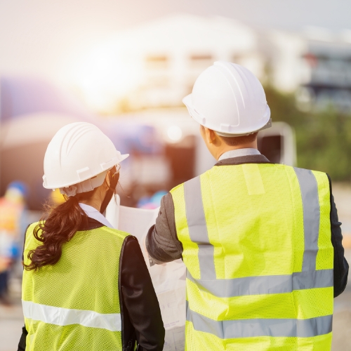 Two people in High visibility vests