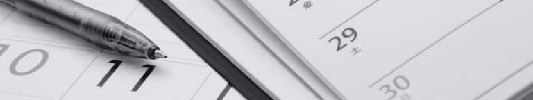 Calendar and pen used to plan interview scheduling