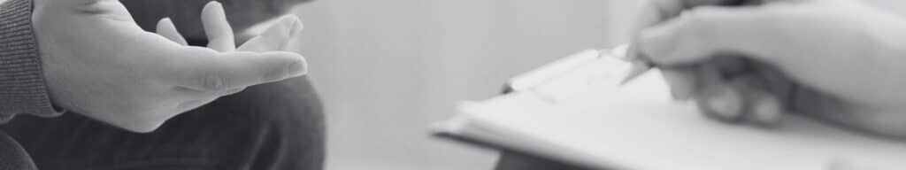 Person holding clipboard and checking boxes on outsourcing readiness assessment