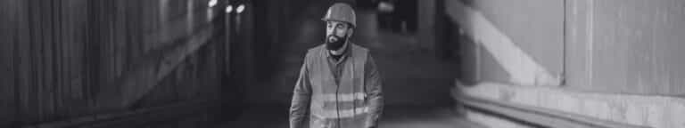 Skilled trades worker walking up a parking garage ramp