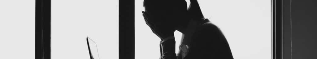 woman with her hands in her head reacting to signs that her hiring process is breaking